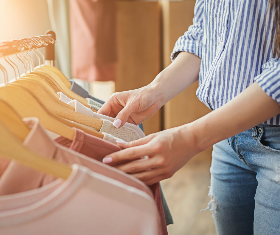 How do I organize my closet? A woman going through items on hangers in her closet