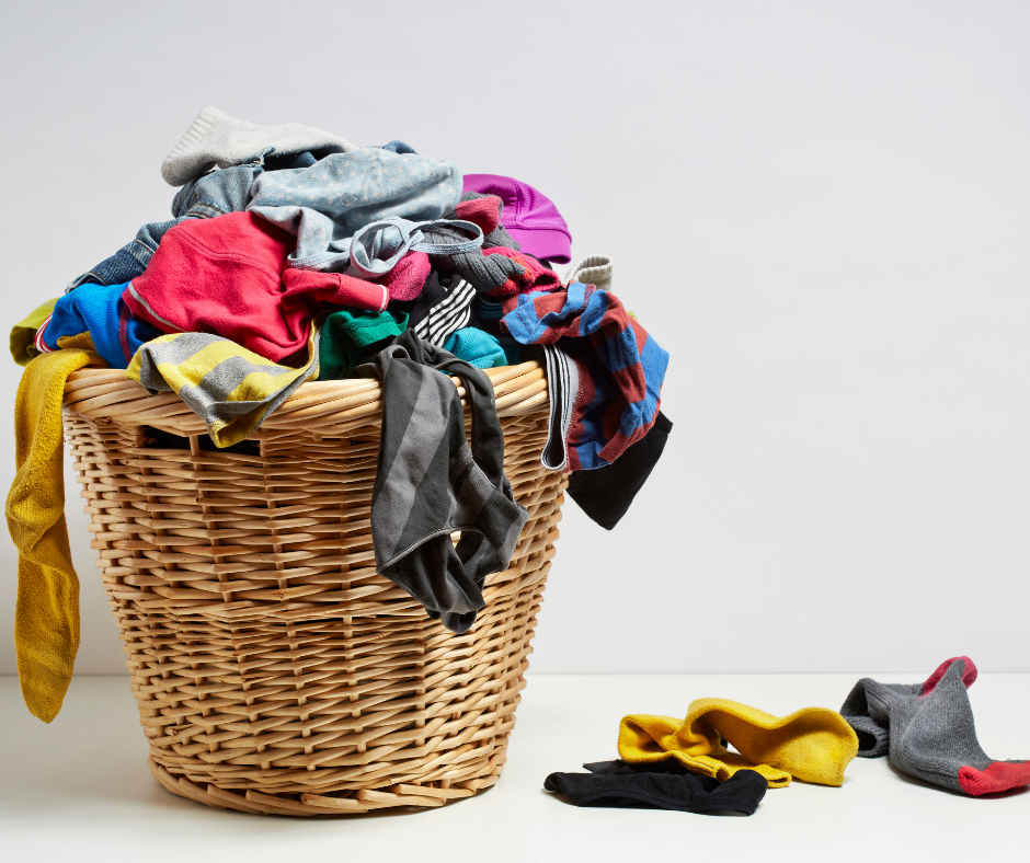 How often should I go to the cleaners? Assorted laundry pilled into a wicker basket